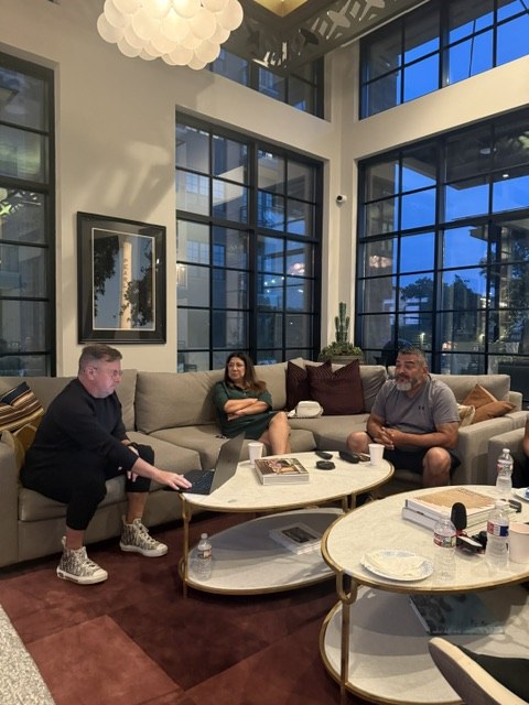 Guests on the couches at the first Bexar AI, September 30, one man with a laptop